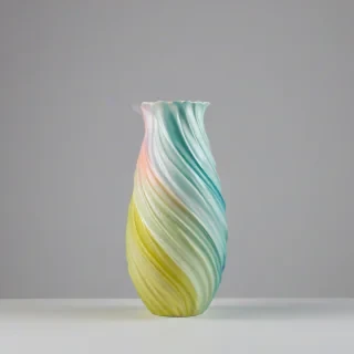 pastel colored vase with a twisted, swirl around the vase, on a plain white background, even lighting