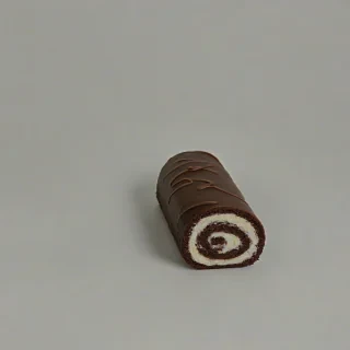 chocolate roll cake, on a plain white background, even lighting
