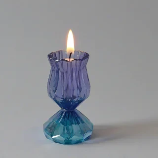 lavender blue colored, multi faceted style candle holder, on a plain white background, even lighting