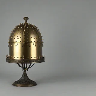 A highly detailed, full-body iron cloche with a metallic sheen, and brass spikes, with bright lighting, on a plain white background, even lighting
