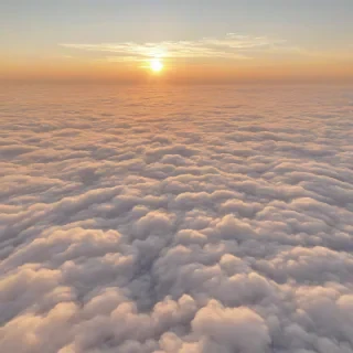 A serene and breathtaking view of a vibrant sunset above a sea of fluffy white clouds, with warm golden light casting a gentle glow on the cloud tops, in a wide-angle shot with a plain white background, full-body view of the clouds and sunset