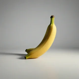 A bright yellow banana with a slight green tip, full-body view, on a plain white background, with a wide shot, and dynamic shadows, in a realistic photography style, on a plain white background, even lighting 