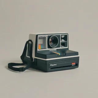 1980's polaroid camera, on a plain white background, even lighting