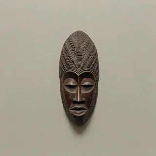 African wood carved mask, on a plain white background, even lighting