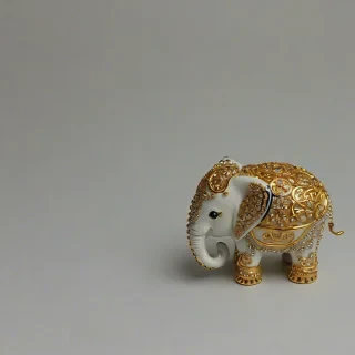 chibi style elephant with gold jewelry on it, on a plain white background, even lighting