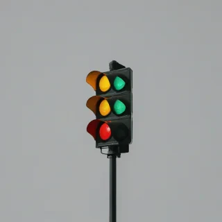 traffic light with red, yellow, and green lights, on a plain white background, even lighting