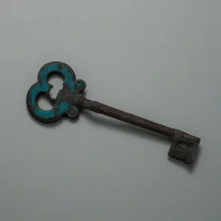 A solitary, old, rusty key, with a cyan patina, in a film noir style, with dramatic shadows, on a plain white background, in a wide shot, with the key's entire body visible, including the teeth and the bow, with a sense of mystery and nostalgia, in a high-contrast, monochromatic color scheme with accents of cyan, on a plain white background, even lighting 