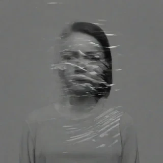 A glitchy image of a woman, distorted camera glitches, black and white
