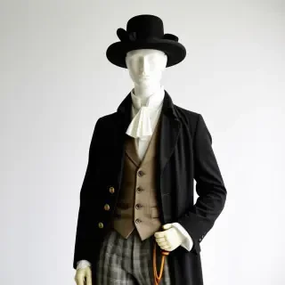 A mannequin wearing 1820s gentleman clothes with a pocket watch and a hat