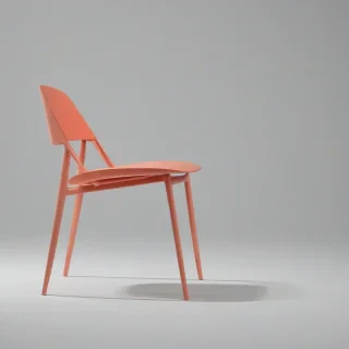 A modern, coral-colored, minimalist chair with clean lines and a low-back design, no background, single chair in image, on a plain white background, even lighting