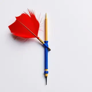 wood dart with red feather and blue string wrapped around the middle