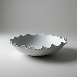 ruffle edge, matte black, low, wide bowl, on a plain white background, even lighting