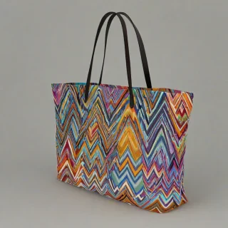 A colorful tote bag with a vibrant Missoni print, featuring a wide shot of the bag with the Missoni pattern prominently displayed, on a plain white background, with the bag's straps and seams visible, in a digital art style with bright colors,, on a plain white background, even lighting