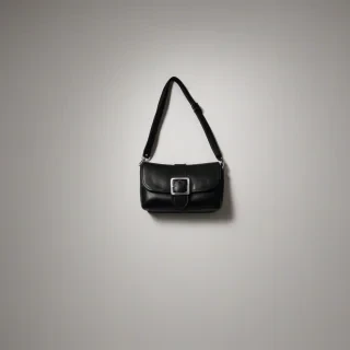 A full-body view of a black leather purse with a silver buckle, and a wide strap, showing the detail of the leather, on a plain white background, in a photography style with soft lighting, on a plain white background, even lighting 