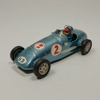 vintage wind up tin race car, on a plain white background, even lighting