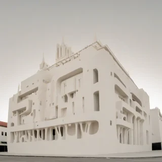 A large, ivory-colored building with a cartoonish architecture style, featuring bold lines, bright colors, and exaggerated details, set against a plain white background, in a full-body view with the entire building visible from the ground up, including the roof and foundation, with a wide-angle shot and dynamic shadows