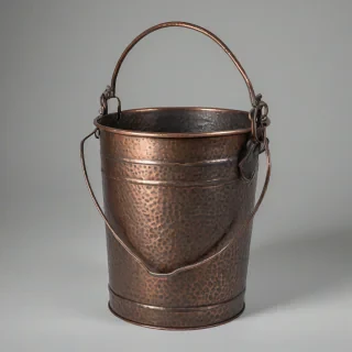 old, worn, copper bucket with iron handle with a D&D style, fantasy, medieval, rustic, and distressed appearance, in a full-body view, on a plain white background, with dimples in the copper, nothing else in the shot, no background, bright lighting, on a plain white background, even lighting