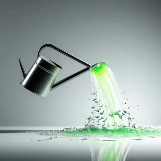 A metal watering can with a long spout, pouring bright green water out in a wide arc, against a plain white background, in a full-body view with the can's handle and feet visible, in a digital art style with bold lines and vibrant colors, with a shallow depth of field and a slight glow effect on the water