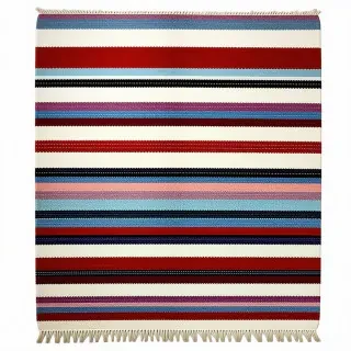 A shaggy rug with stripes of varying shades of red, blue, and purple on it