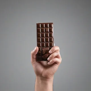 Full-body view of a person holding chocolate, photorealism, plain white background, on a plain white background, even lighting 