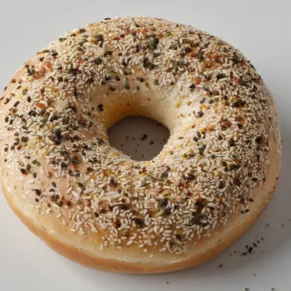 single bagel with everything seasoning, only one in the shot, wide angle shot, on a plain white background, even lighting